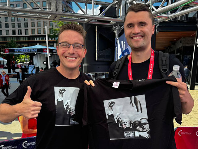 two men holding up t-shirts
