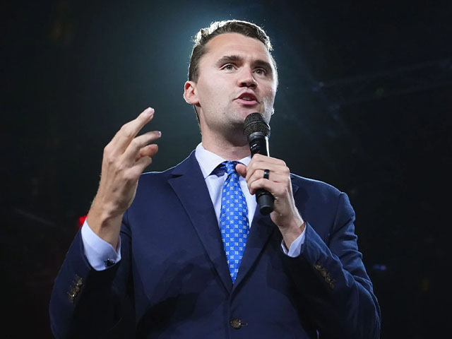 a man in a suit and tie holding a microphone